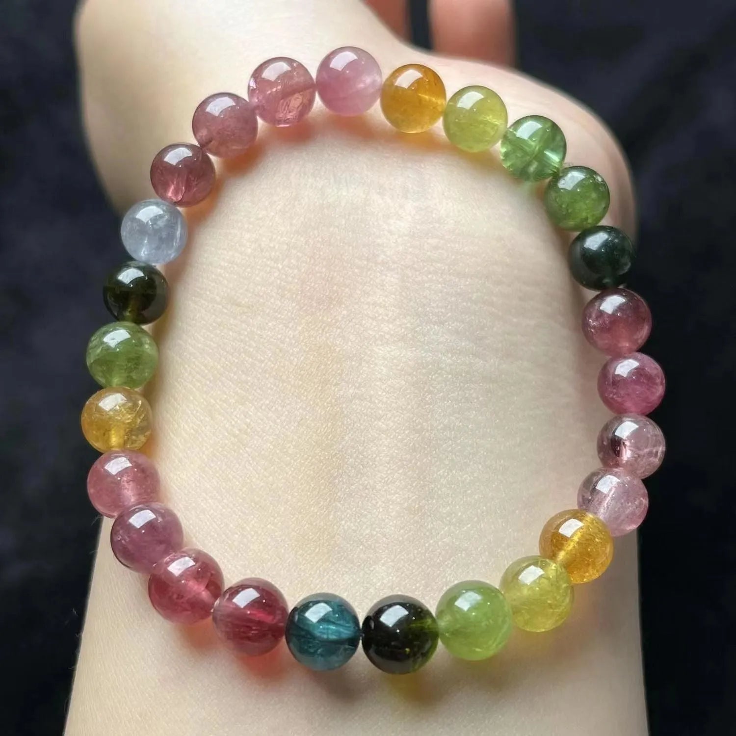 Women's silver-tone bracelet with a drop-shaped four-leaf clover pearl charm and colourful tourmaline stones on a geometric link band.