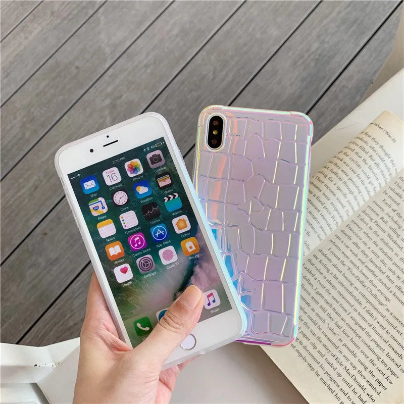 Silver glossy silicone laser phone case with textured surface for iPhone, showing lanyard hole and precise camera cutout.