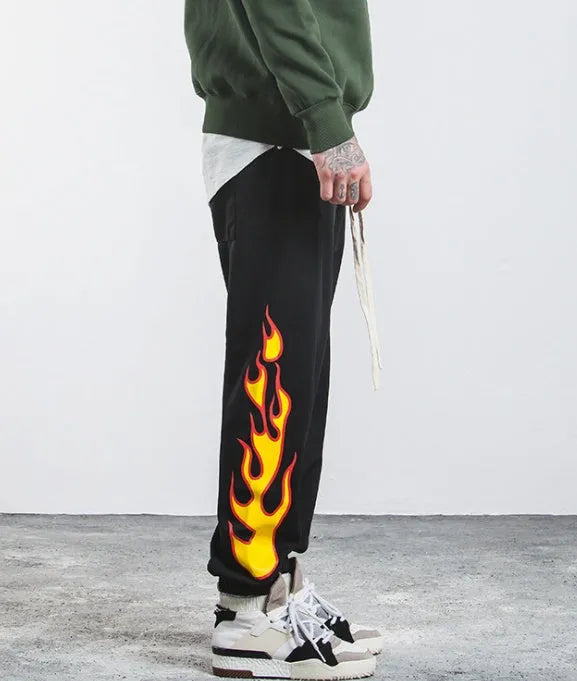 Hop flame print joggers for men and women in black, loose fit cotton blend sweatpants with red, blue flame pattern