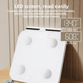 White professional body fat scale with eight electrodes and a large tempered glass platform.