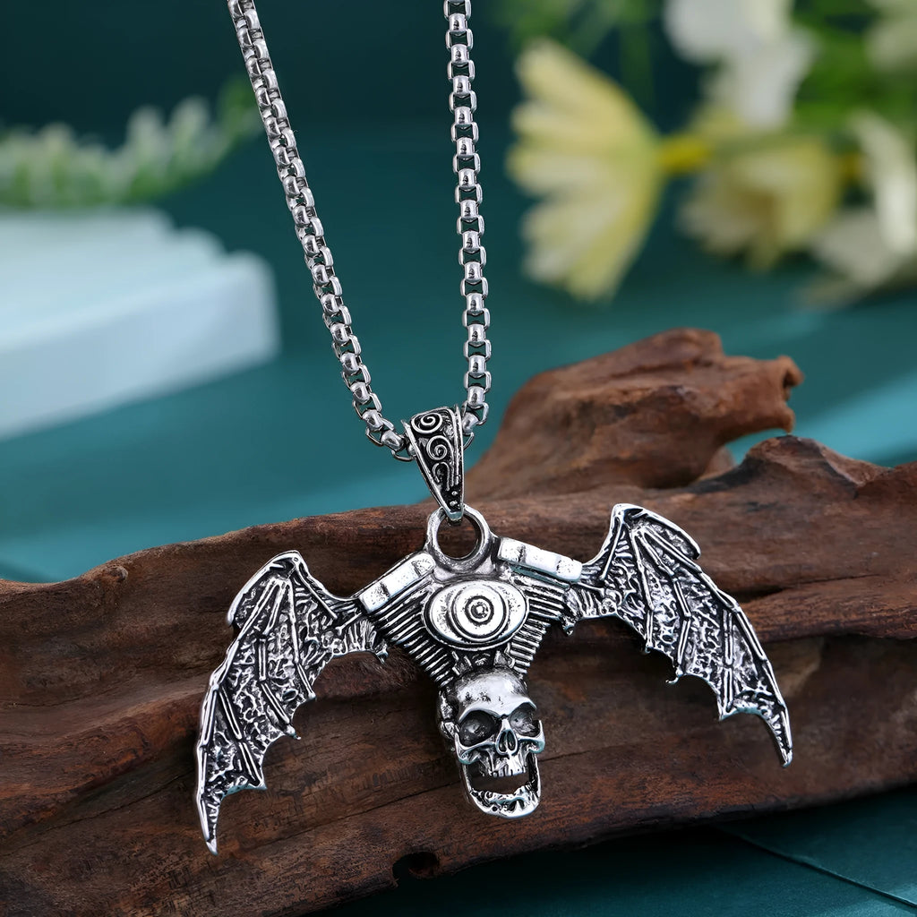 Gothic dark alloy skull pendant necklace with skeleton wing detail on matte black background