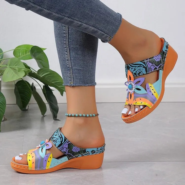 Women's cowhide sandals with coloured slope heel and totem pattern in black, purple, green, and orange.