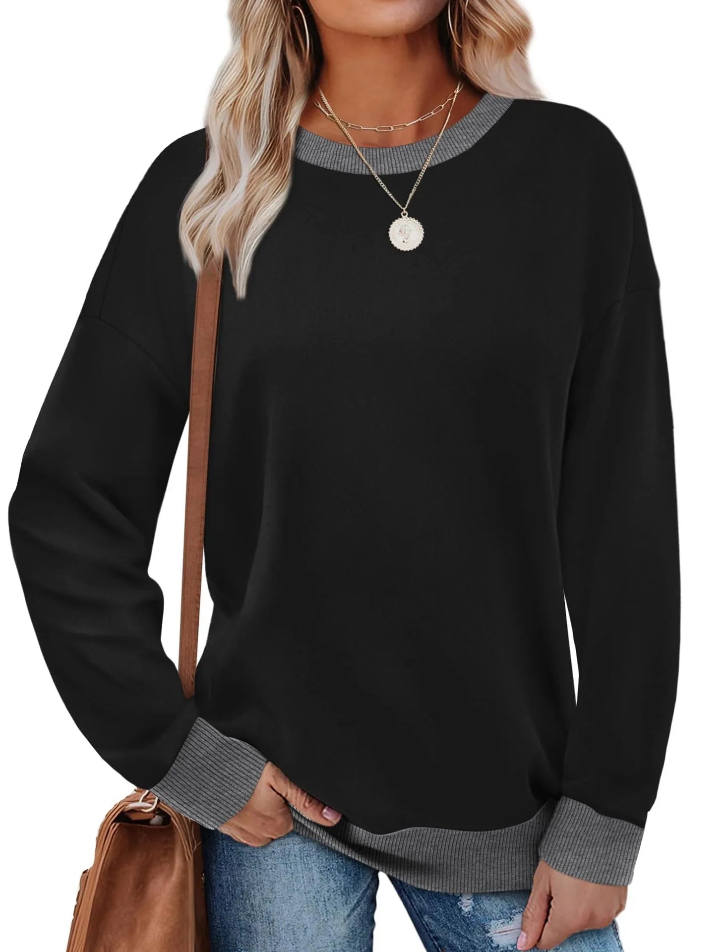 Woman wearing a loose-fitting striped long sleeve top with a round neckline in a grey colour.