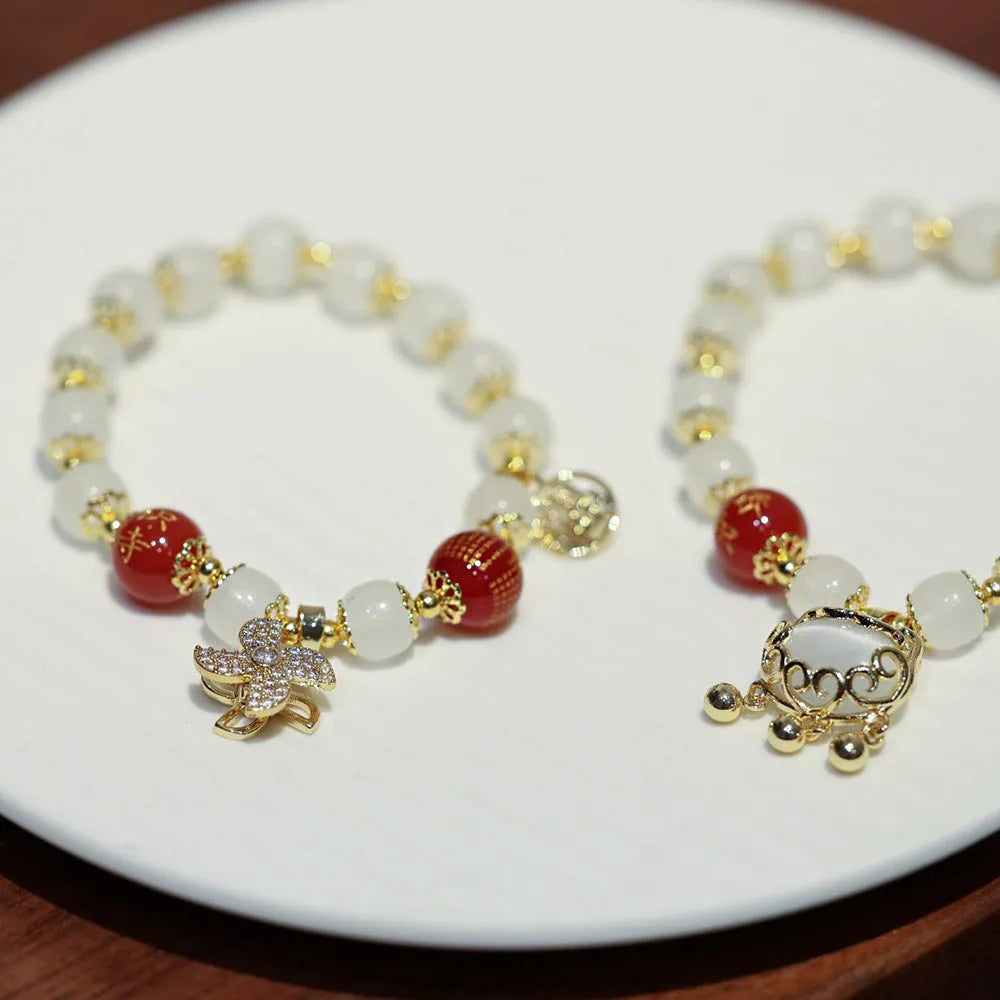 Chinese-style glass bracelet with coloured glaze, fu character, safety lock, windmill and bamboo presages charm designs