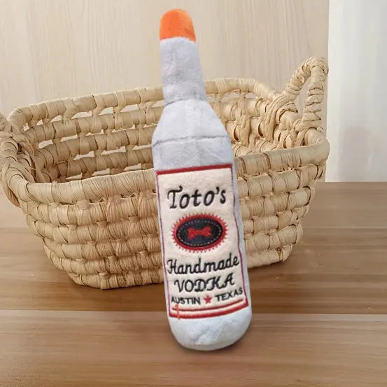 Brown plush wine bottle shaped dog toy with molar detailing for chewing