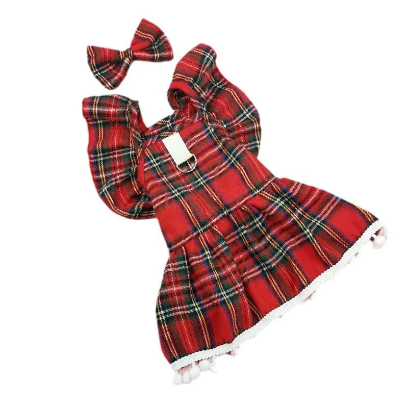 Red tartan Christmas skirt and matching head flower on a pet, with a jingling bell necklace accessory.