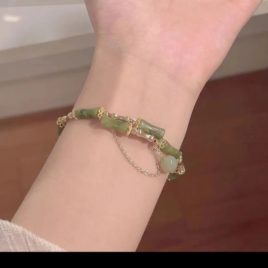 Women's bamboo bracelet with coloured glaze beads and a plum wine coloured bamboo joint centrepiece.