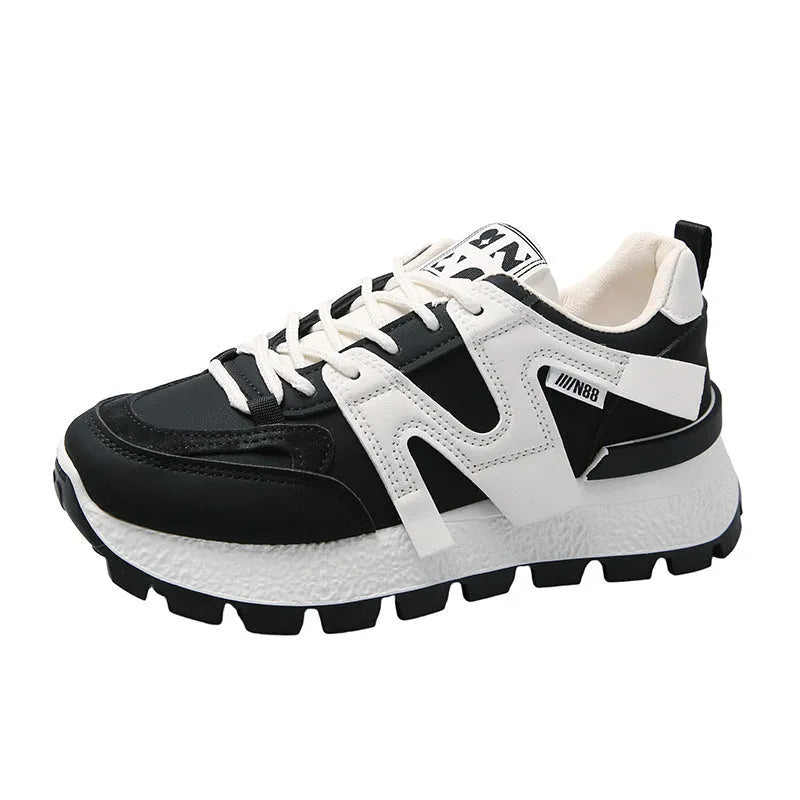 Low top running sneaker in white with round toe and lace-up front on rubber sole