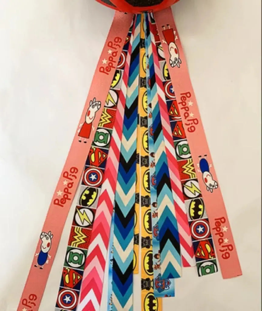 A decorative ribbon streamer for attaching to a child's roller skate or ski helmet, shown in a selection of colours.