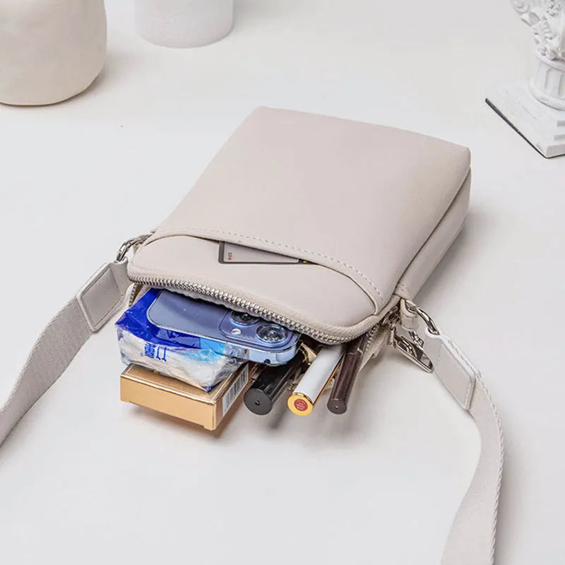 Solid colour PU leather crossbody phone bag for women in beige, showing front view.