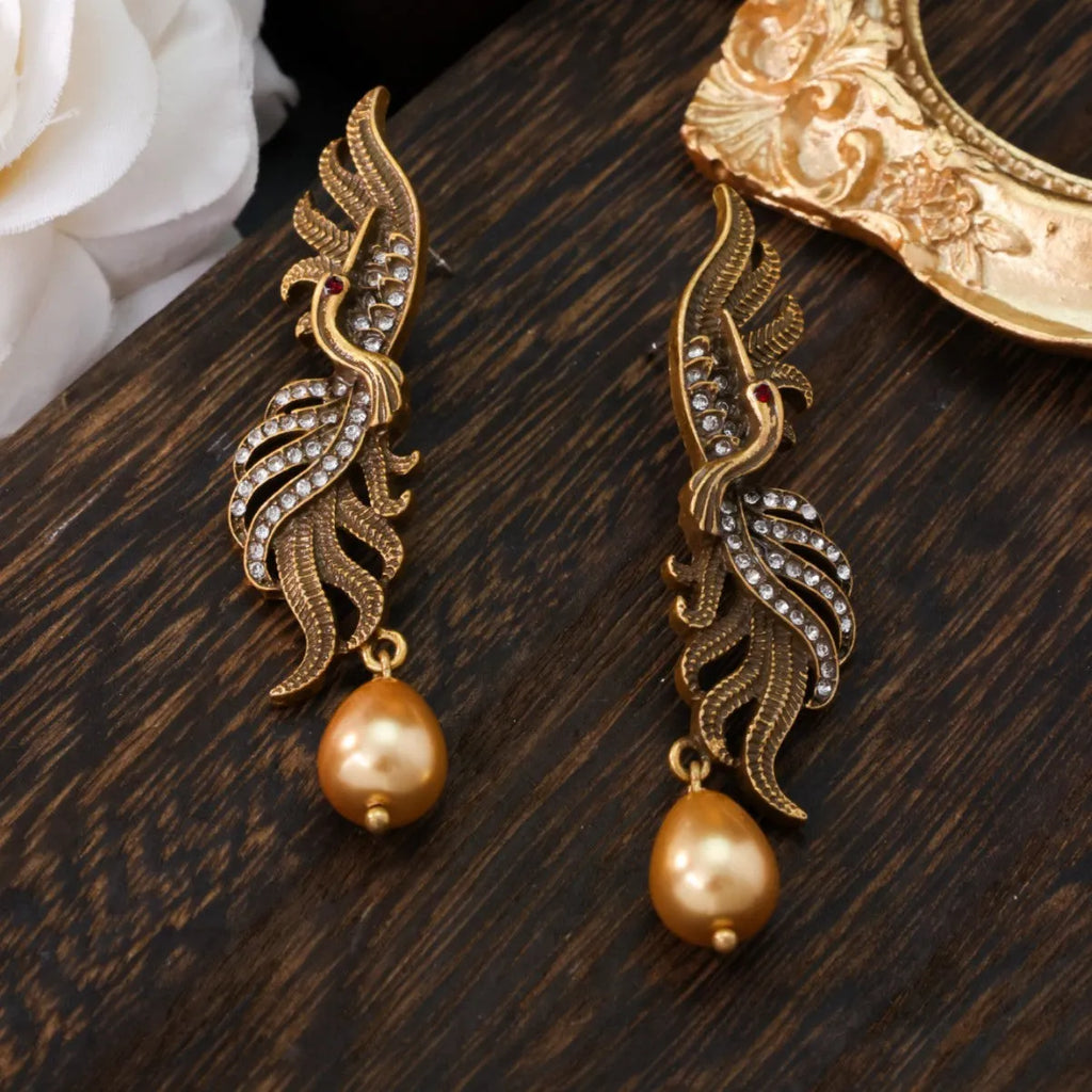 Pair of phoenix drop earrings in gold-tone electroplated alloy, hollow jeweled distressed design, 7cm by 1.6cm.