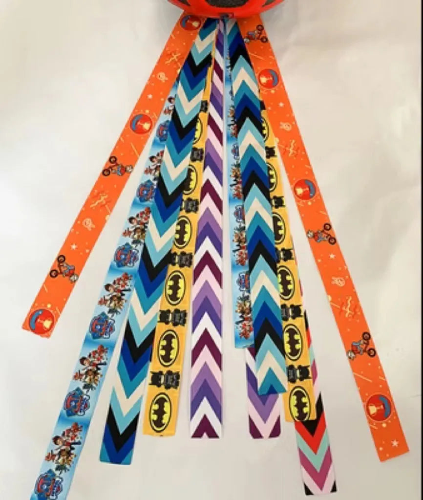 A decorative ribbon streamer for attaching to a child's roller skate or ski helmet, shown in a selection of colours.