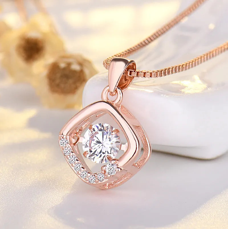 Silver heart necklace with crown and bow detail on a model.