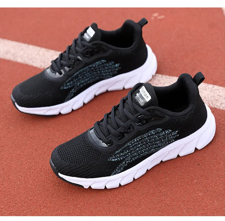 Women's low-top black and white casual running sneakers with MD sole and cross-strap detail.