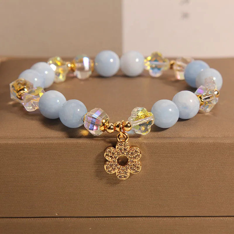 Women's aquamarine crystal bracelet with four-leaf clover charm and pearl decorative accents