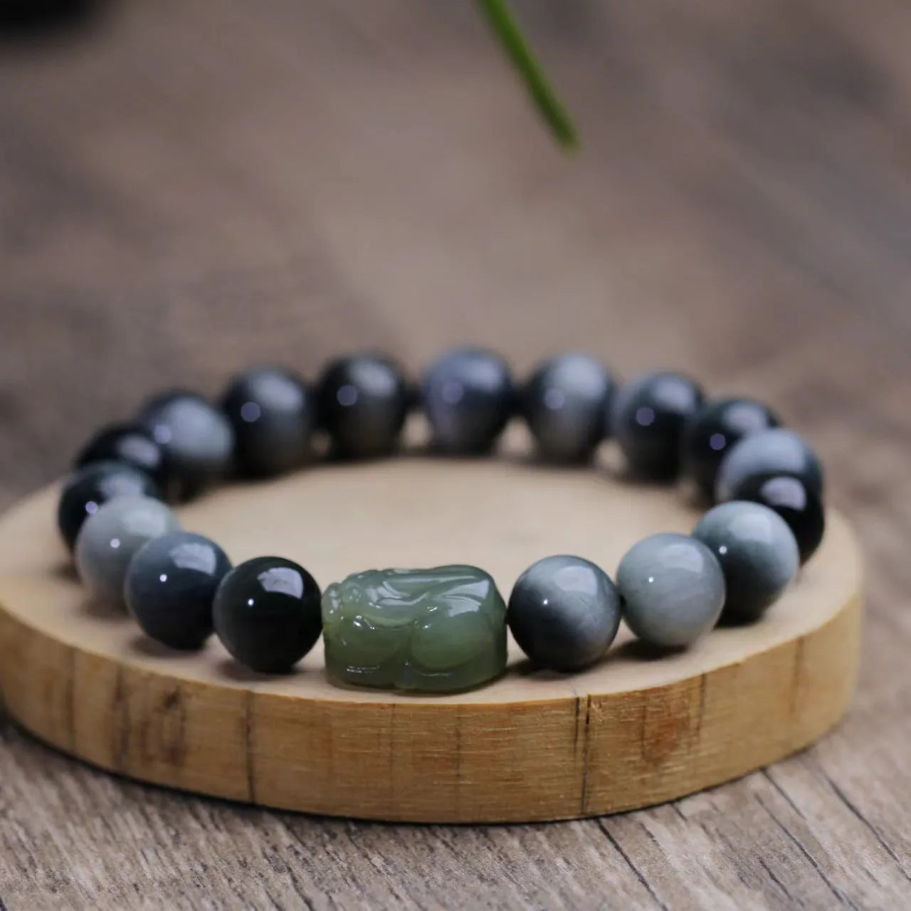Black bracelet with 10mm Eagle Eye stone beads and a Hetian Jade Pixiu charm.