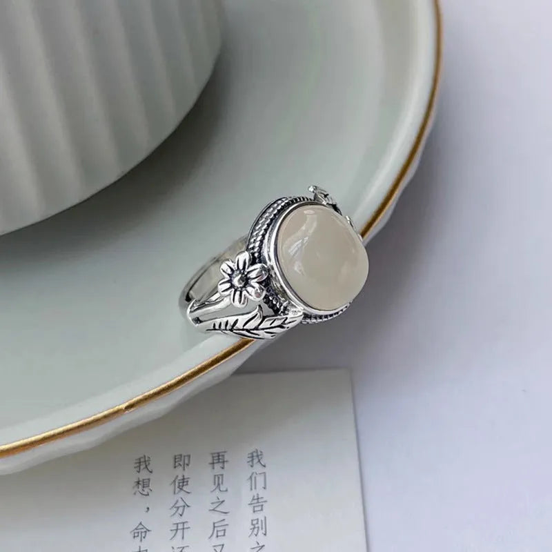 Copper vintage ring with white stone and adjustable U-shaped band.