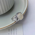 Copper vintage ring with white stone and adjustable U-shaped band.