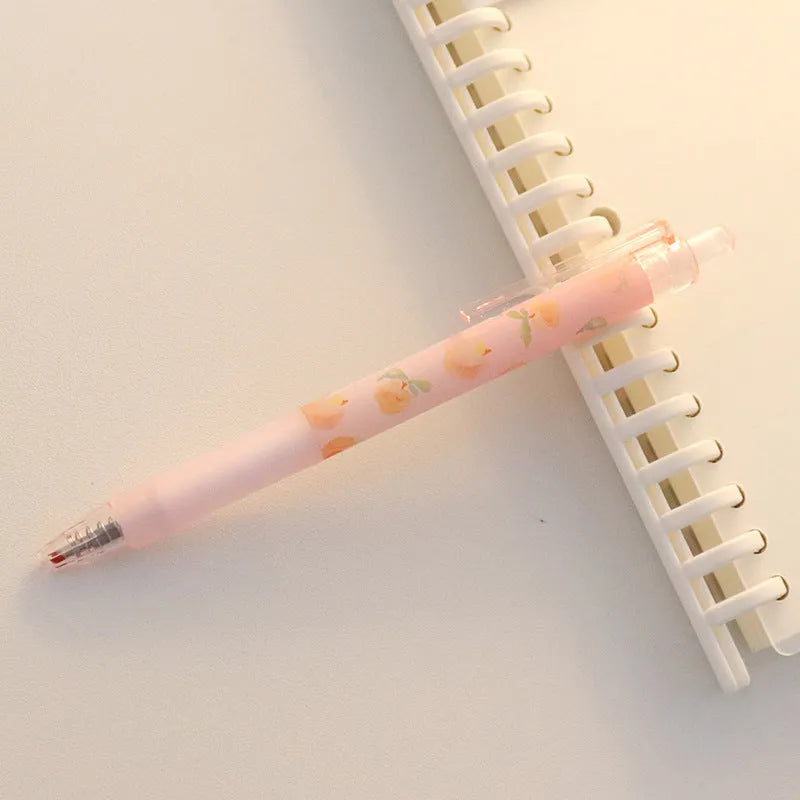Cute Peach press gel pen with 14cm plastic body and rollerball tip against white background