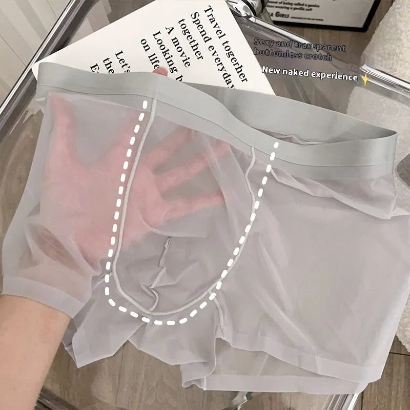 Man wearing thin grey seamless nylon boxer shorts with a mid-waist design.