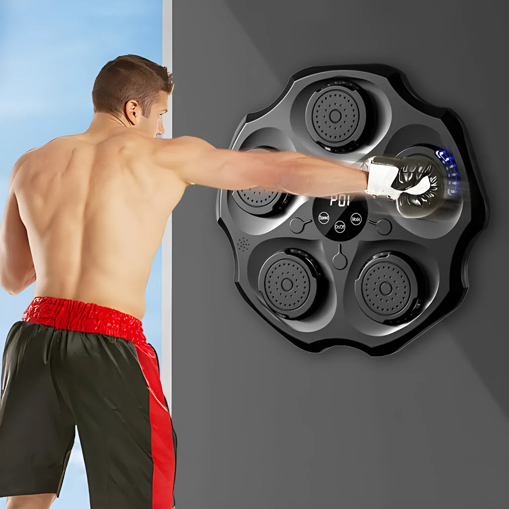 Black hanging boxing wall target with Bluetooth logo and included boxing gloves on a home wall.