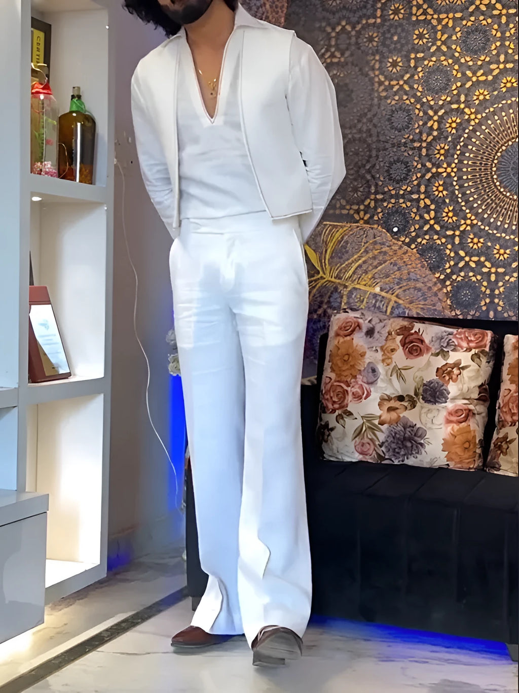 White three-piece outfit comprising V-neck shirt, sleeveless vest and trousers on hanger