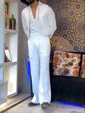 White three-piece outfit comprising V-neck shirt, sleeveless vest and trousers on hanger