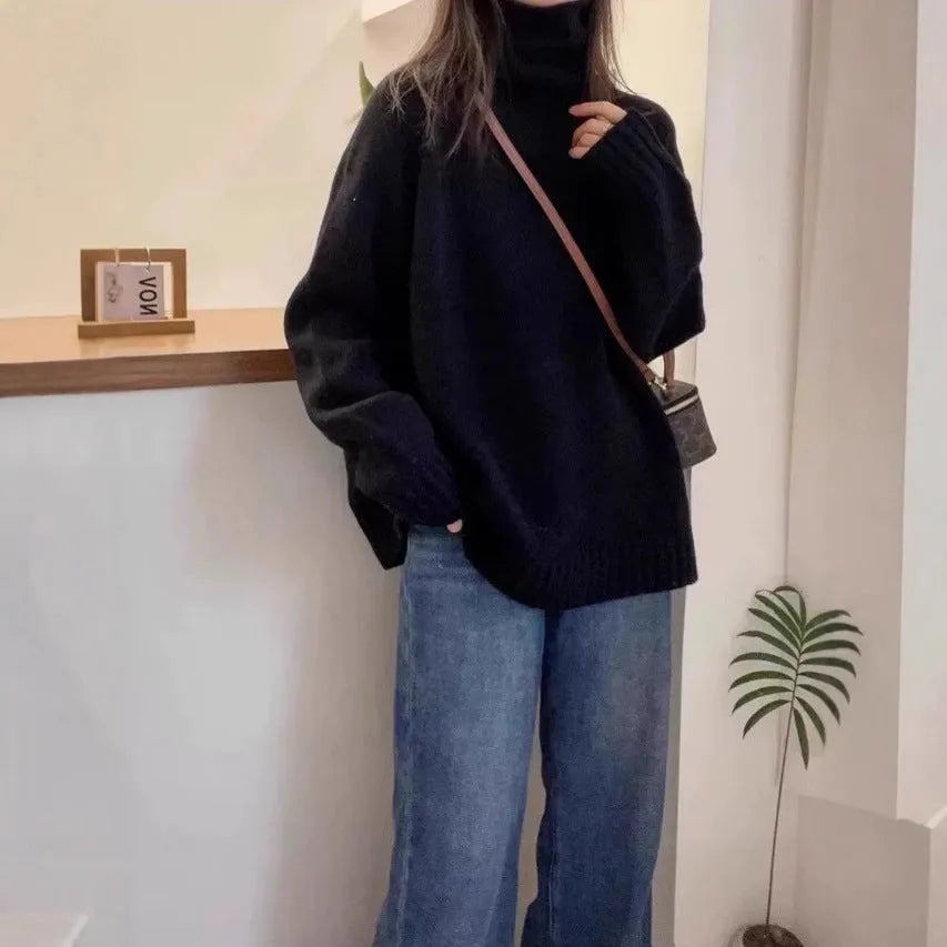 Women's loose fit grey turtleneck sweater with a thick curling pile collar on a hanger.