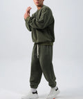 Men's black polar fleece sports suit set with long sleeve coat and loose trousers on a hanger.