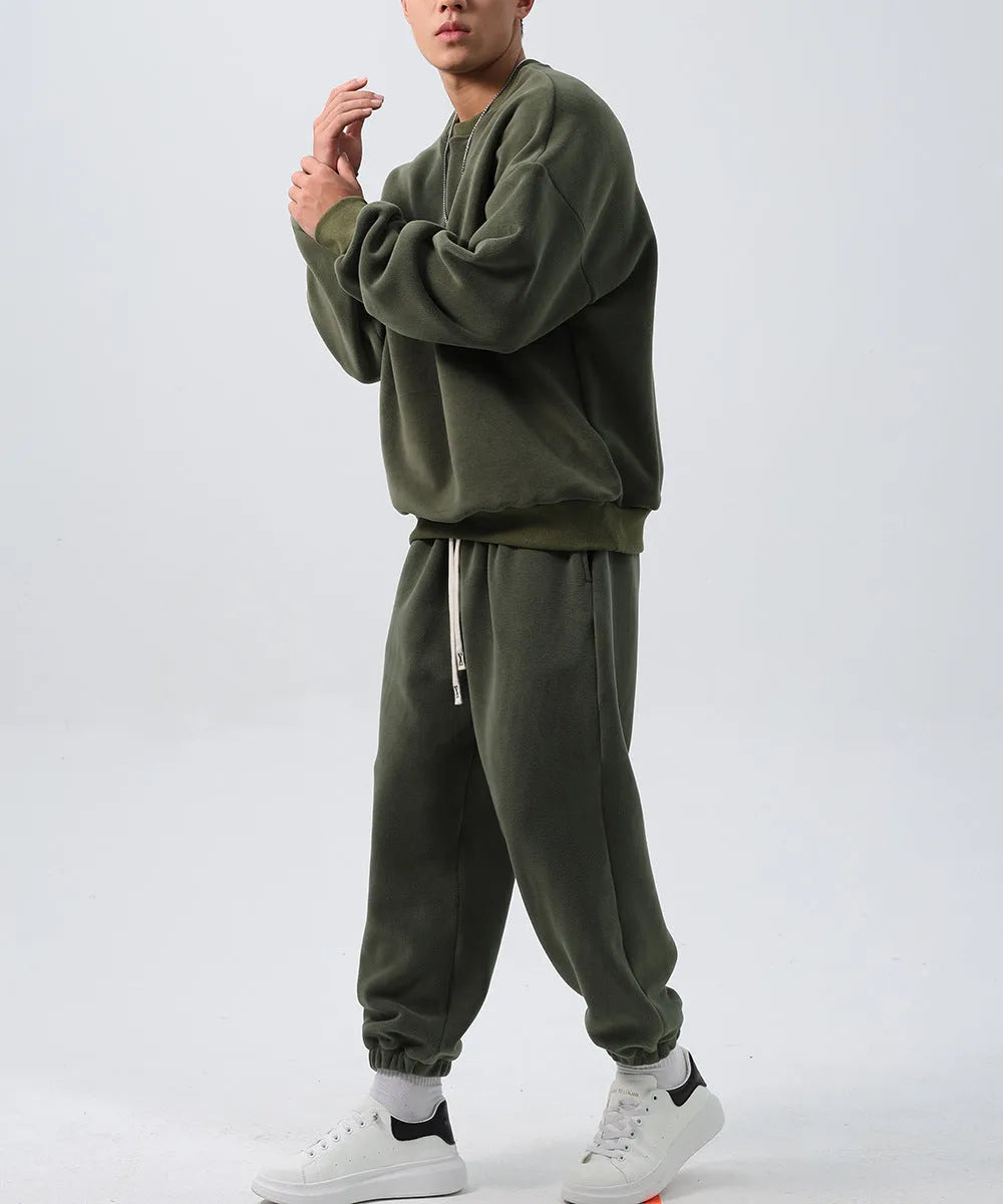 Men's black polar fleece sports suit set with long sleeve coat and loose trousers on a hanger.