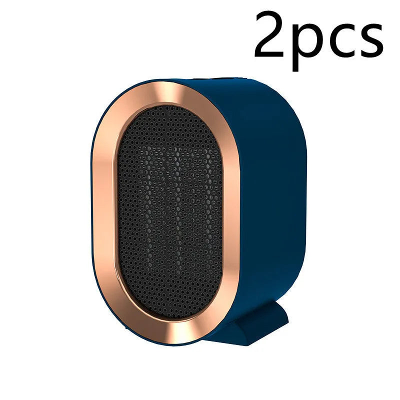 Compact black desktop electric fan heater with a front grille and mechanical control dials.