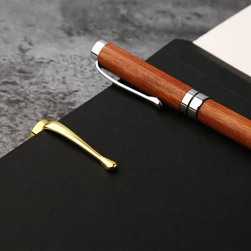 Gold metal and rosewood ballpoint pen 14cm long with cap