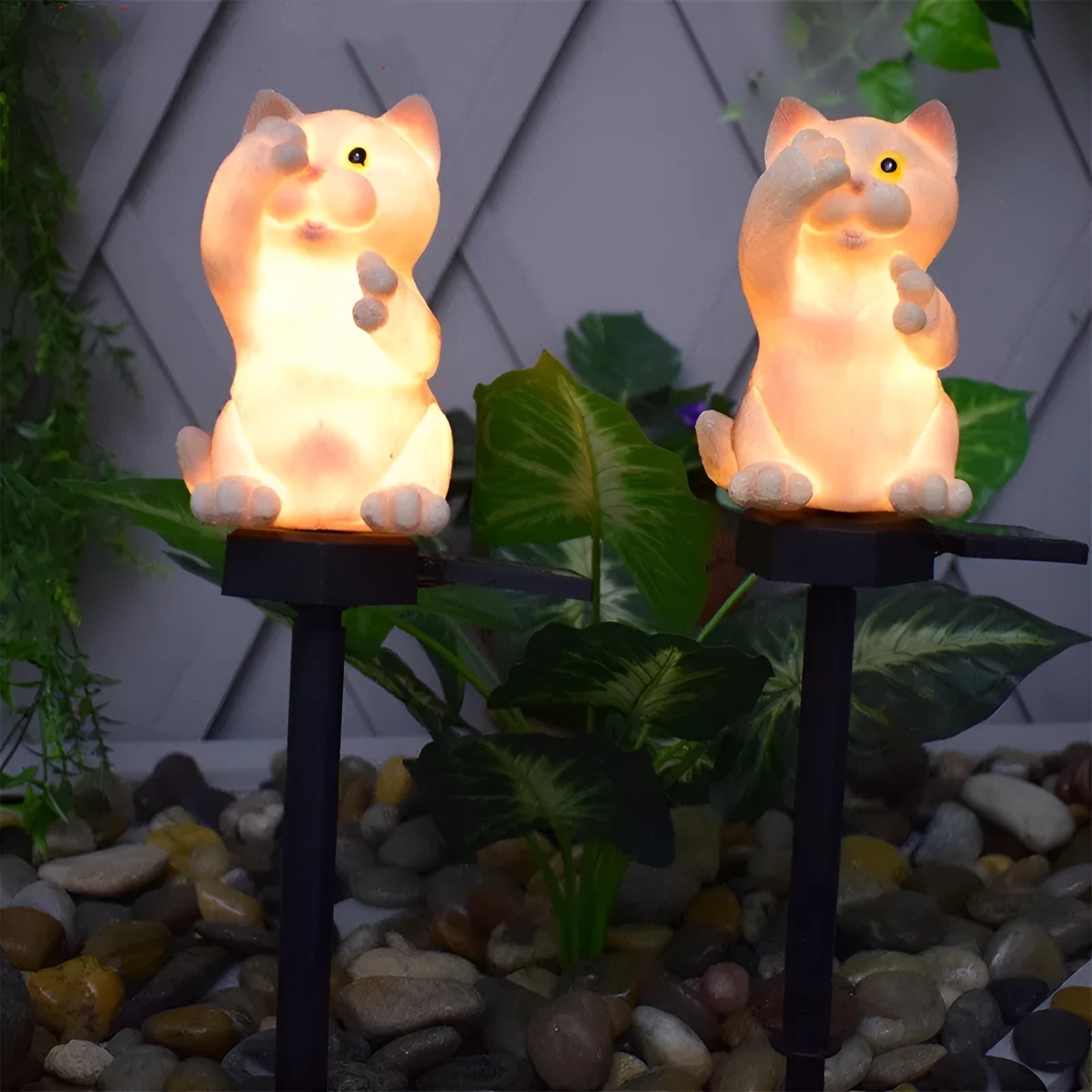 Brown cat-shaped solar lawn light with LED, placed in a garden.