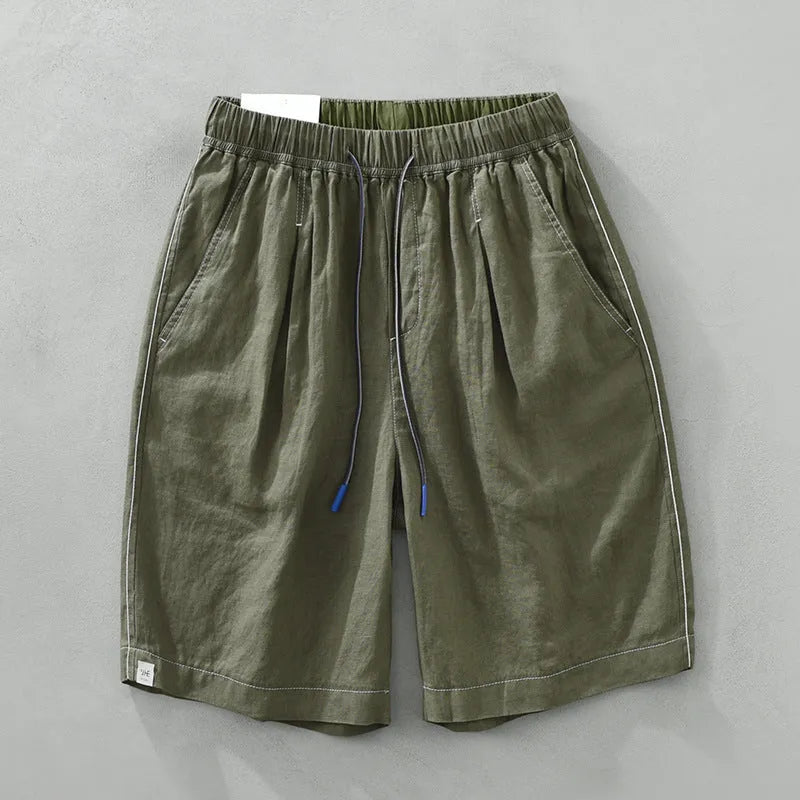 Men's loose fit linen shorts in green on a hanger, showing straight leg and drawstring waist.