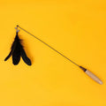 Cat teasing stick toy with wooden handle, bell, and feather head in selected colour