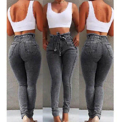 Pair of blue fringed jeans with a distressed hem laid flat, showing cowboy fabric texture.