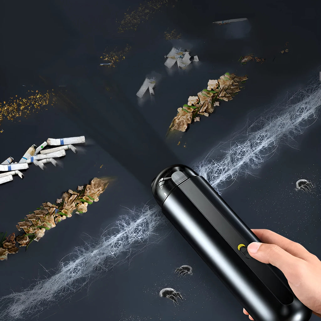 Starry sky black handheld cordless car vacuum cleaner with blowing hose accessory on a desktop.