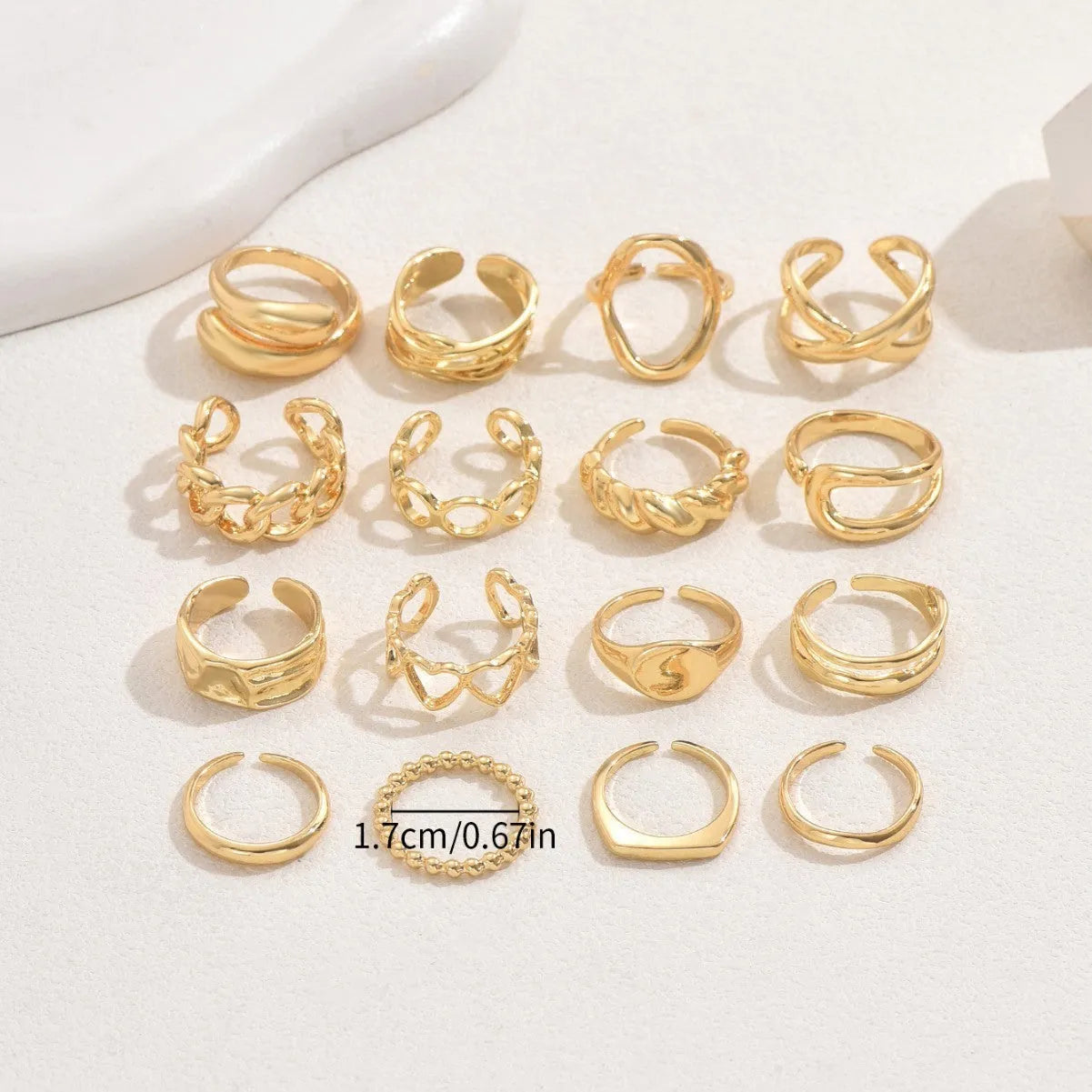 Women's 16-piece open ring suit in silver and gold zinc alloy geometric shape on display