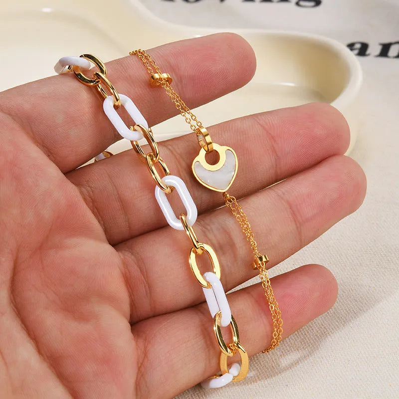 Women's silver stainless steel bracelet with a double-layer red heart charm and magnetic clasp.