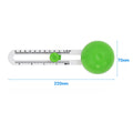 Green plastic round rotary paper cutter on a desk next to an A3 sheet of paper.