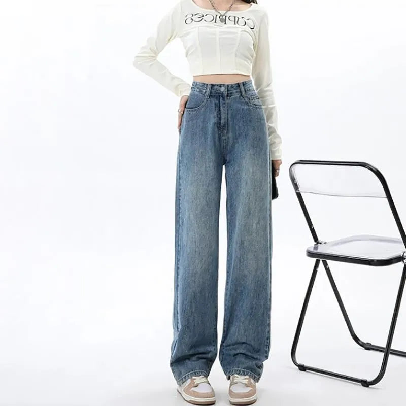 Woman wearing high-waisted retro blue wide-leg denim jeans with a straight cut.