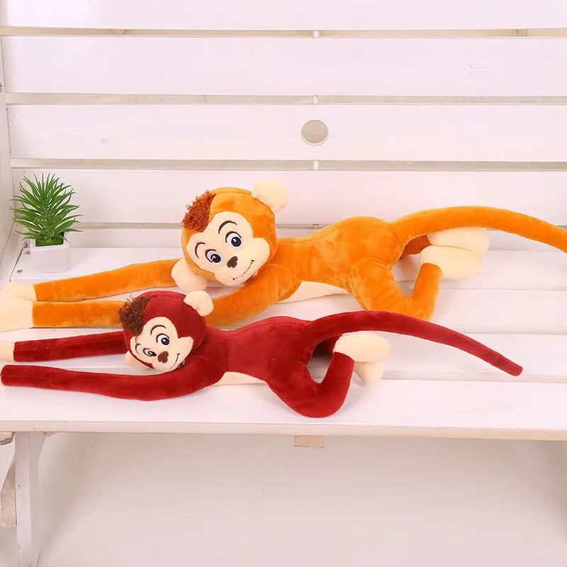 Long arm plush monkey toy hanging over a curtain pole in dark brown colour.