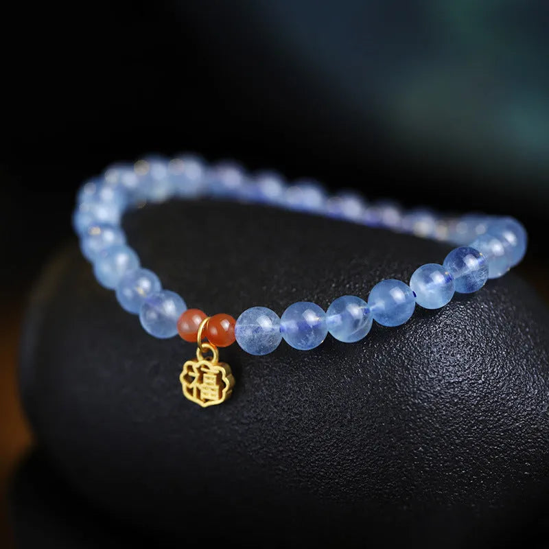 Icy translucent aquamarine crystal bead bracelet with sequin charm and blessing card.