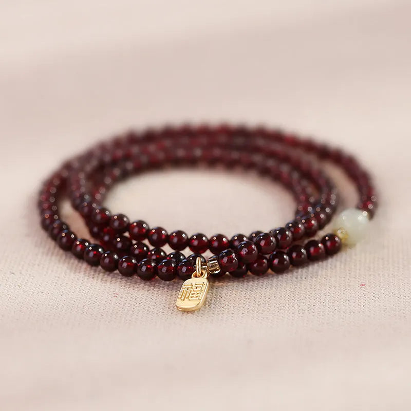 Antique style Chinese bracelet with U-shaped design and floral red garnet imitation gemstones