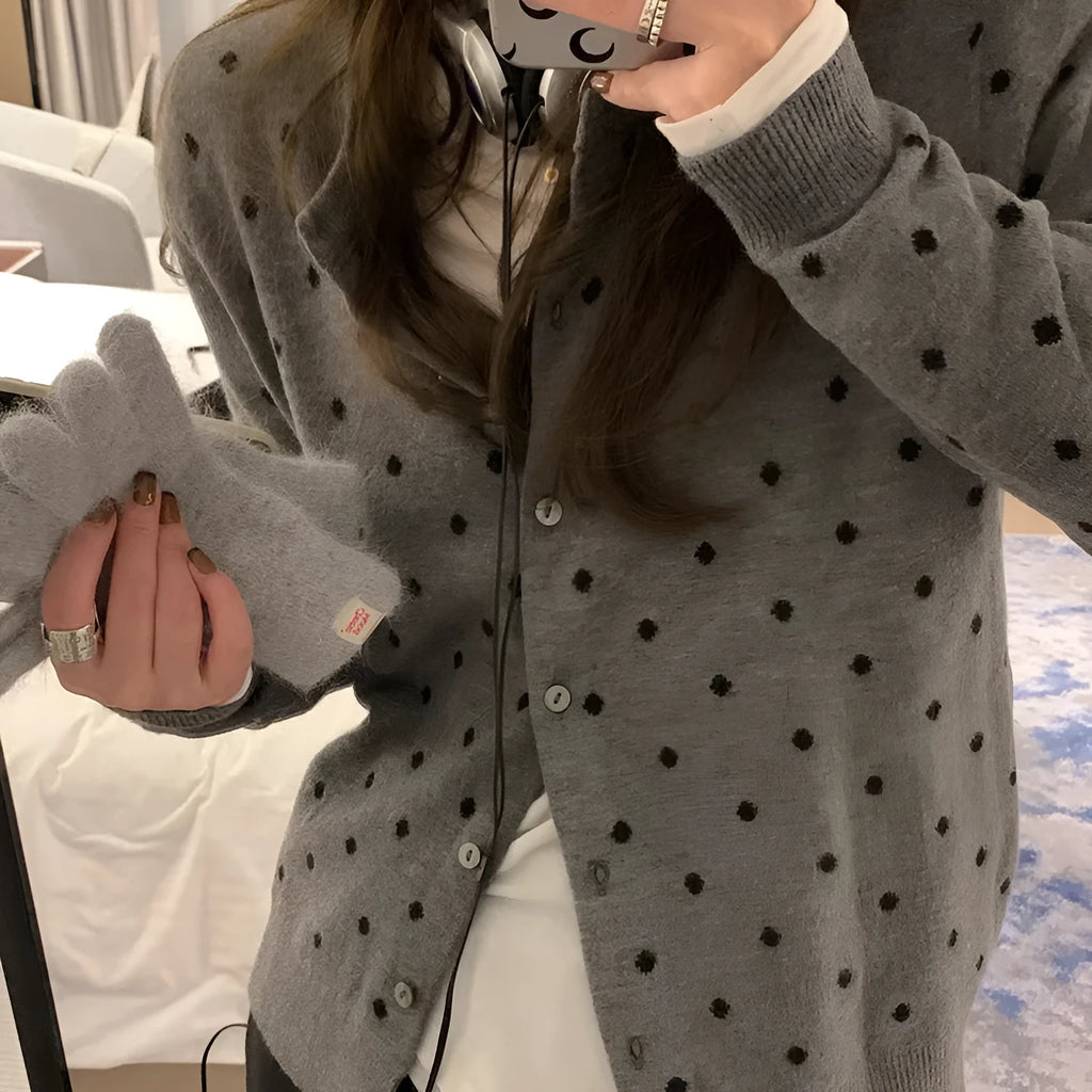 Women's grey dot print knitted cardigan with white crocheted flower detail on sleeve