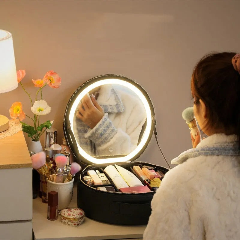 Round pink PU leather makeup bag open showing illuminated mirror and internal partitions.
