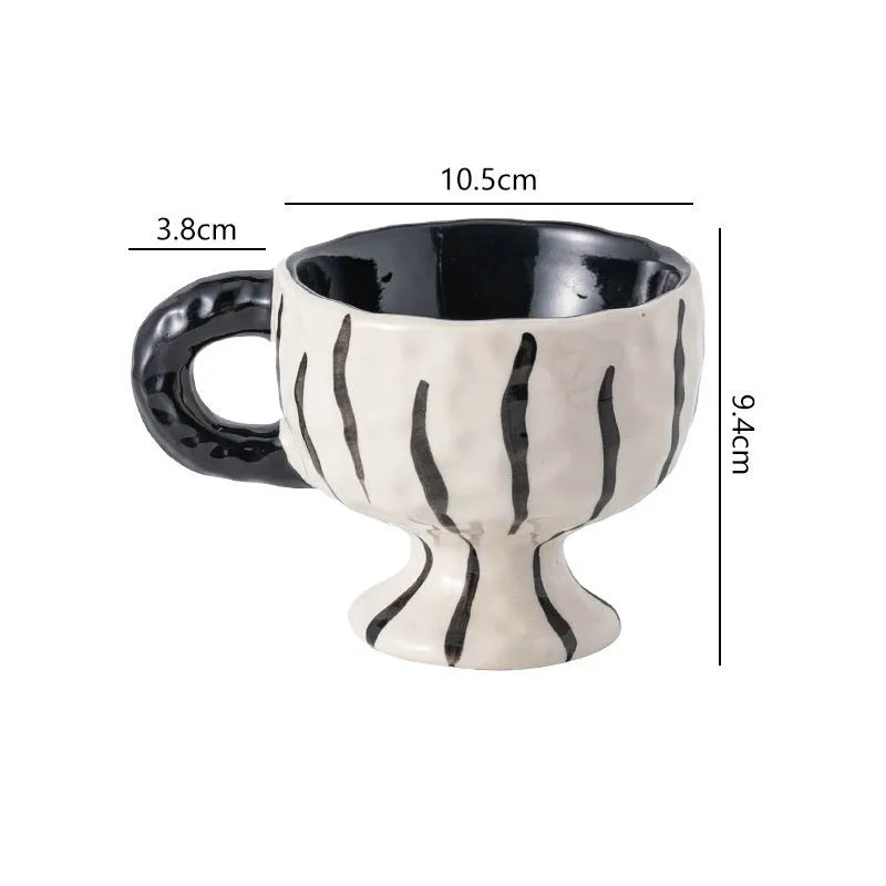 Irregularly shaped hand-pinched ceramic mug in a solid colour, shown on a plain background.