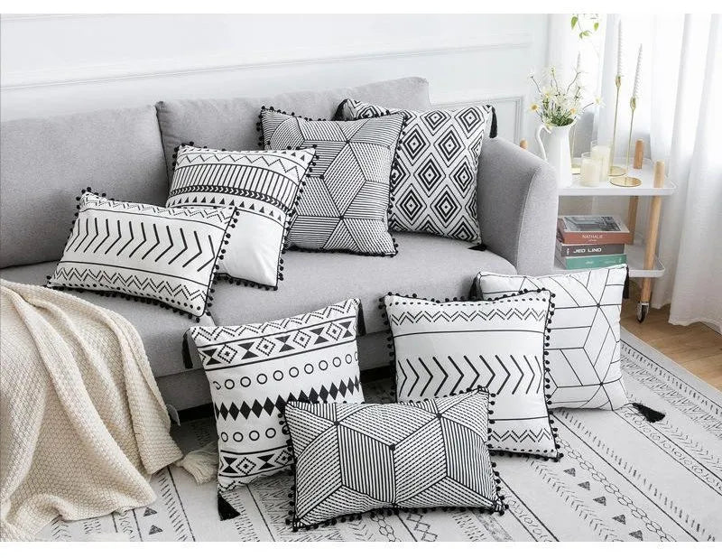 Bohemian national style polyester cushion cover in light grey on a sofa.