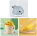 Whale-shaped baby bath toy with automatic water spray, flashing lights, and music on a base.