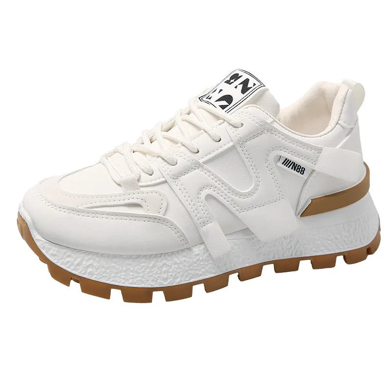 Low top running sneaker in white with round toe and lace-up front on rubber sole